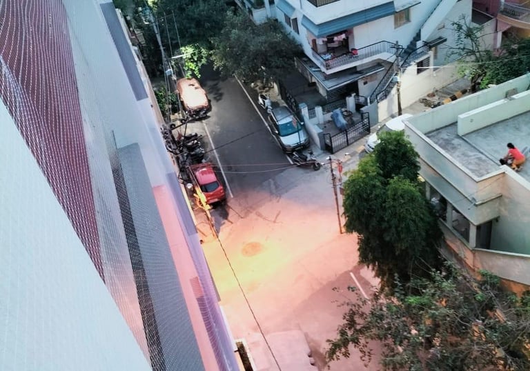 Close-up of a securely installed safety net covering a duct area in an industrial setting.
