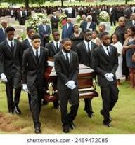 Pallbearers in black suits carry a wooden casket during a formal burial service at a cemetery.