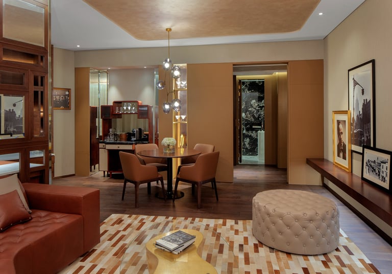 a living room with a couch, chairs, and a table