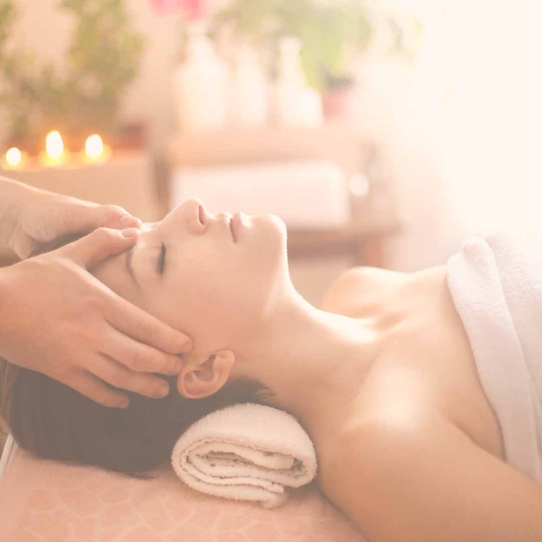 A relaxed woman receiving a calming facial head massage at Zen Massage Therapy Norfolk