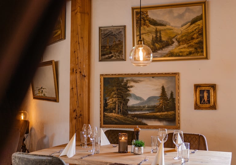Ein einladender, rustikaler Restaurant-Dining-Bereich im Hotel mit einem gedeckten Holztisch
