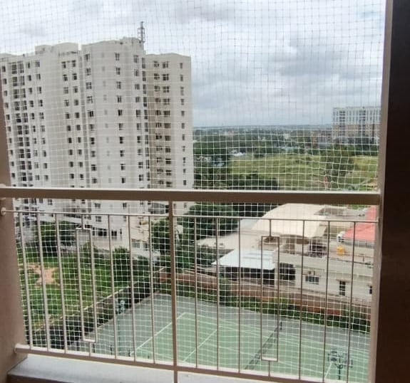 Wide view of a residential building in Thoraipakkam fitted with anti-pigeon nets by Arjilli Enterpri