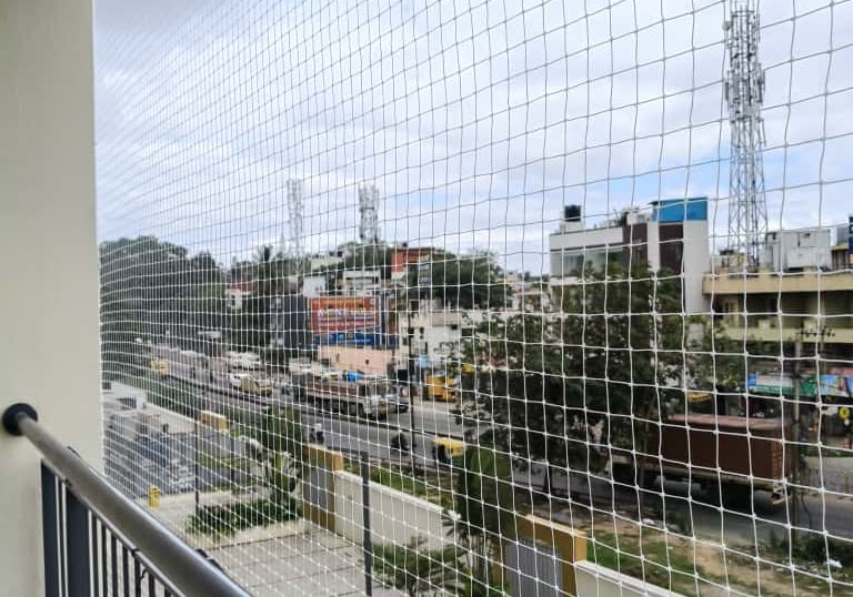 Close-up of a neatly installed pigeon net on a residential balcony in Hongasandra.