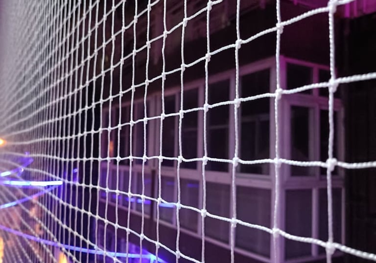 Close-up of a clean, well-maintained pigeon net stretched tightly across a balcony.