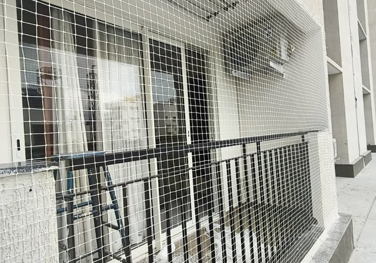 Close-up of a sturdy balcony safety net securely fastened around a Pallavaram apartment balcony.