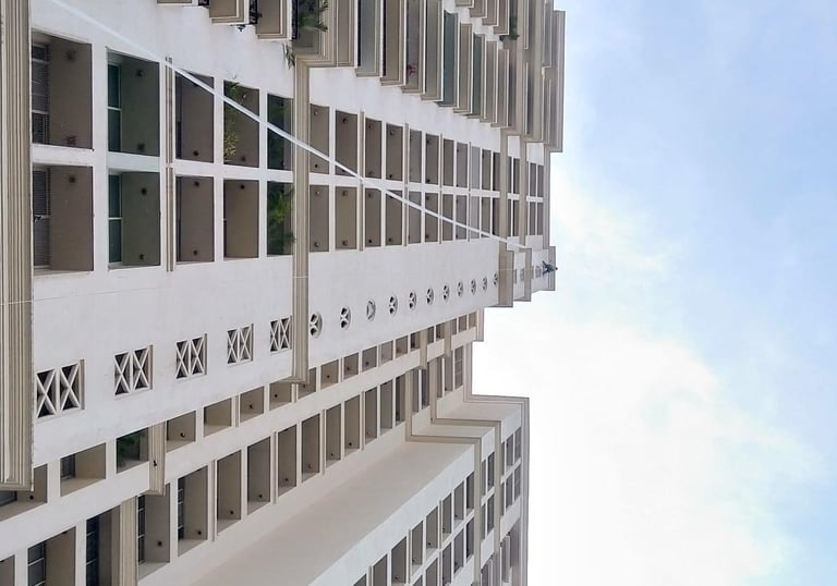 Wide view of an apartment building in Ambattur with installed safety nets on ducts.