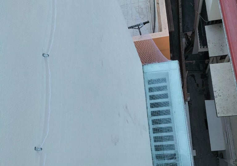 Technician from Arjilli Enterprises carefully fitting a pigeon net on an apartment duct in Bengaluru