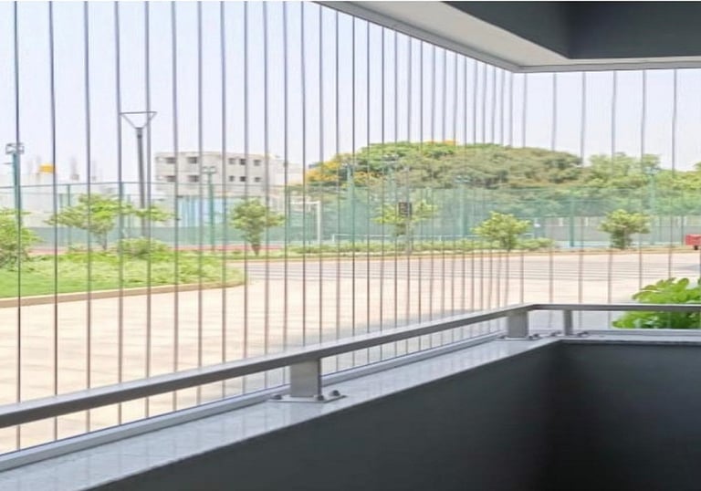 Daylight view showing the almost invisible safety grills on a Royapettah home window.