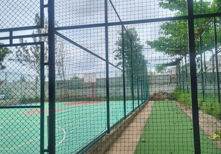 Close-up of a volleyball practice net installed on a rooftop terrace.