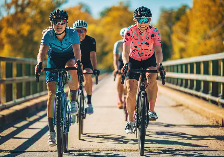 Recreational athletes cycling alone the road