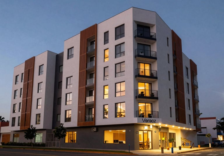 Exterior of a sleek, modern commercial building or apartment complex in a vibrant part of Veracruz, Mexico, shot at dusk with warm interior lights.