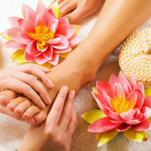 a woman's feet and hands on a towel