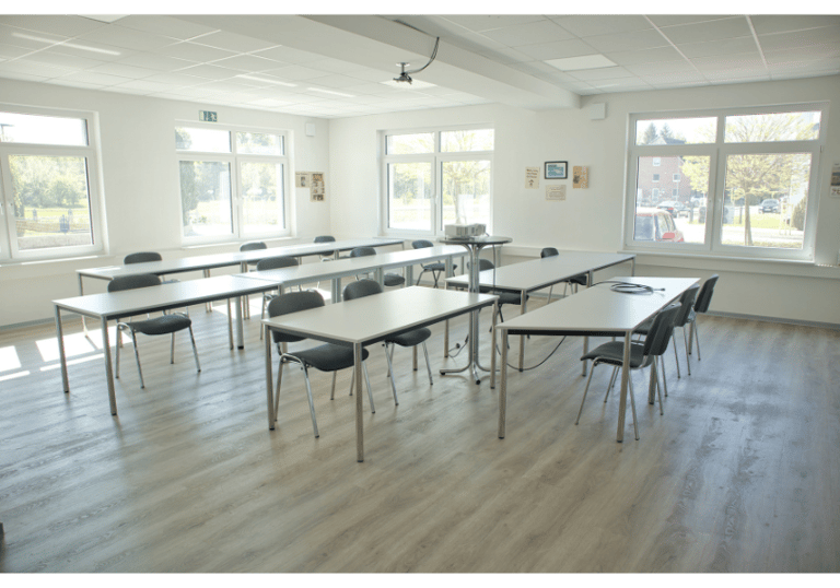 a room with a table and chairs and a table Paderborn