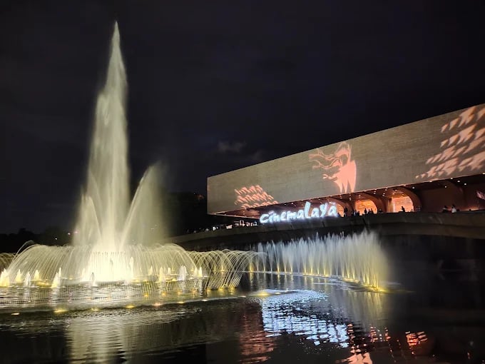 a fountain with a large screen showing a movie screen and a large screen with a