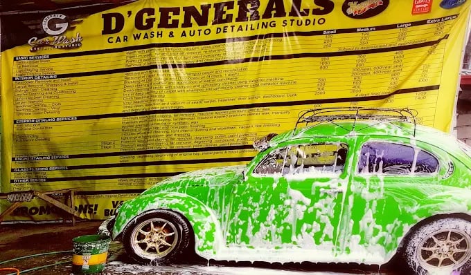 a green car being sprayed with foam paint