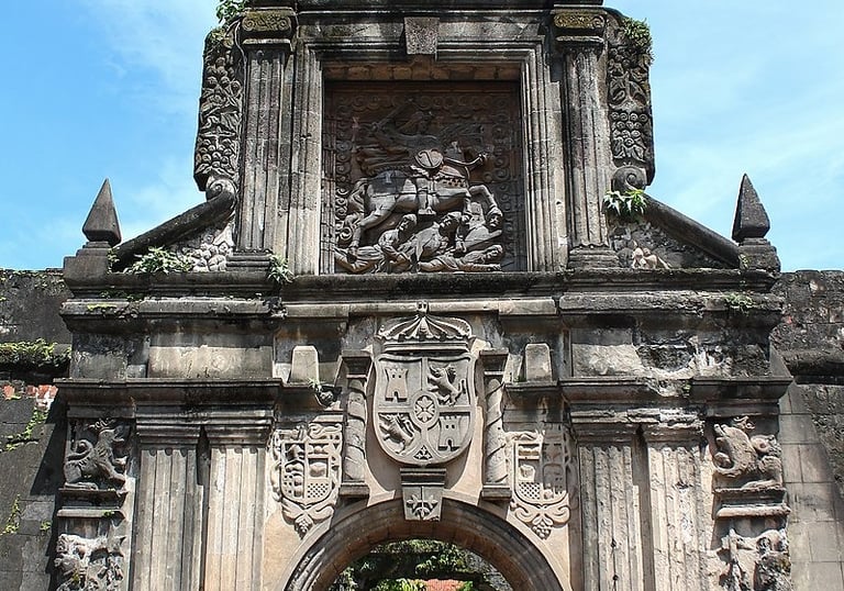 a large stone archway with a clock on it