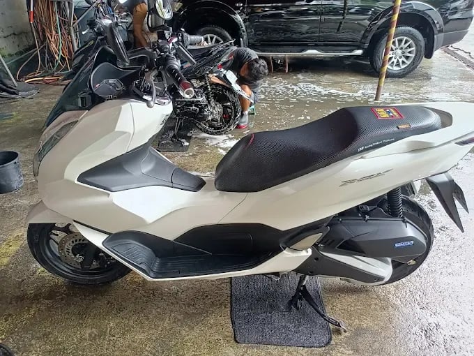 a motorcycle parked in a garage with a motorcycle