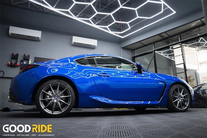 a blue car with a blue flame painted on it