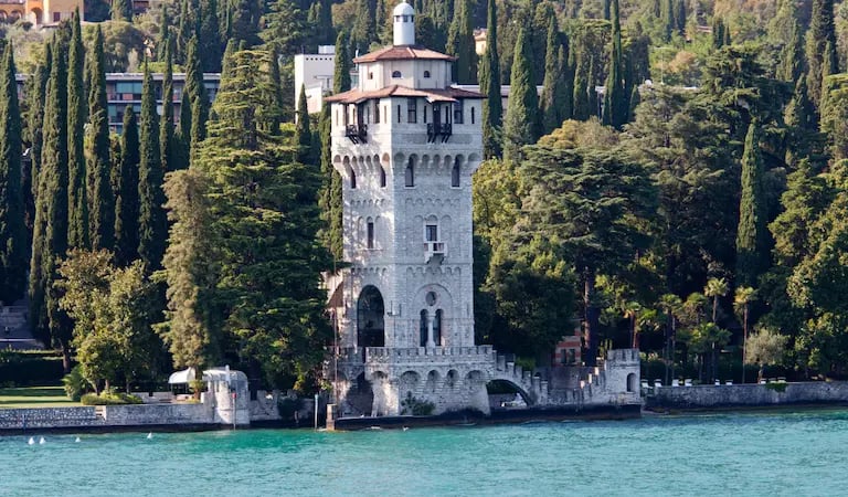 Torre San Marco reflected in Lake Garda, Gardone Riviera waterfront.