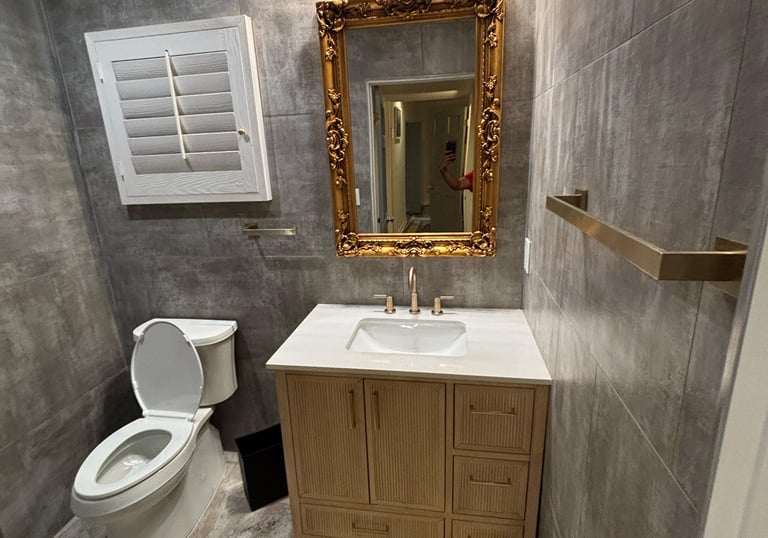 a bathroom with a toilet and a mirror