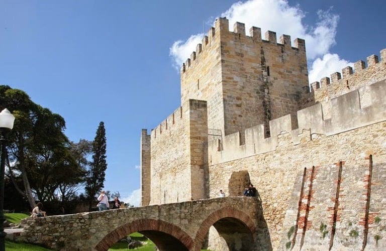 a castle like structure with a bridge over a river
