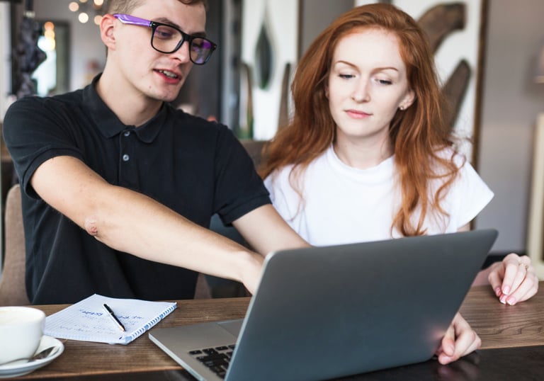 Freelance web designers collaborating in a co-working space, reflecting the early days of EZ Web Bui