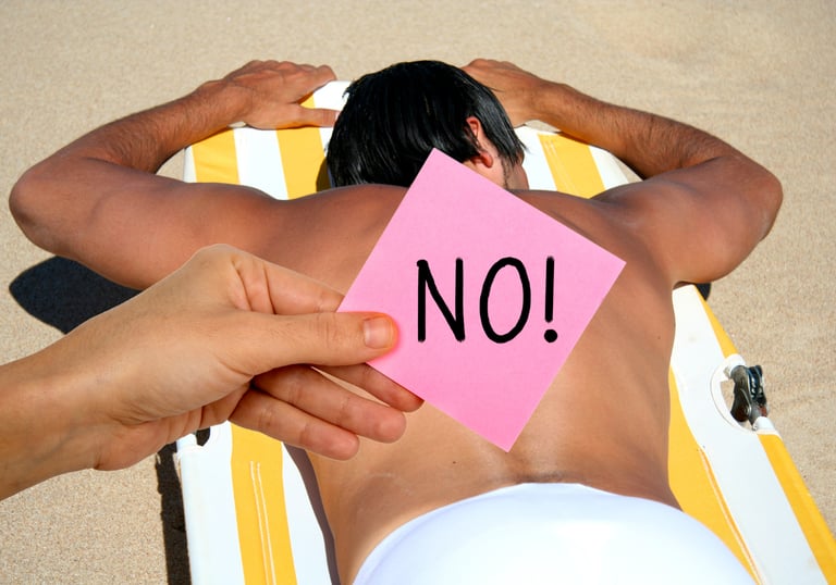 a man sitting on a beach chair with a note pad on his back