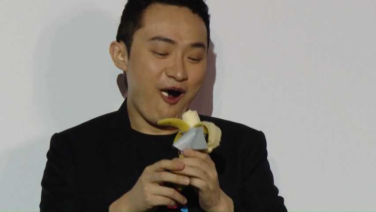 a man in a black jacket and a banana peeler