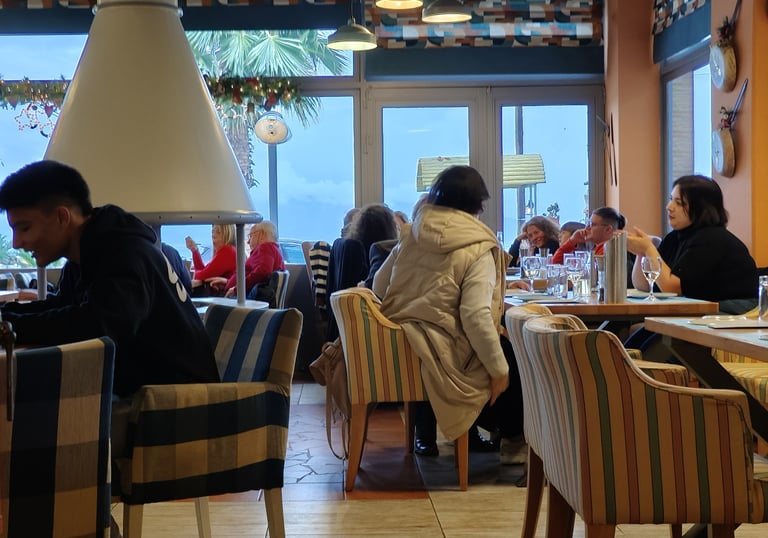 a group of people sitting at a table in a restaurant