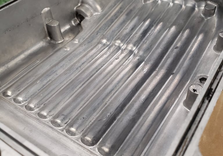 Honda CB oil pan after getting cleaned and vapor blasted. 