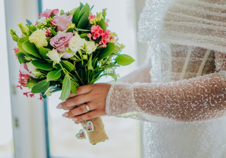 a bridesmaid holding a bouquet of flowers