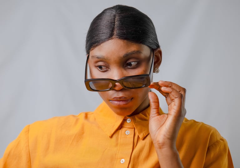 Black woman captured in a studio portrait with a soft white background.