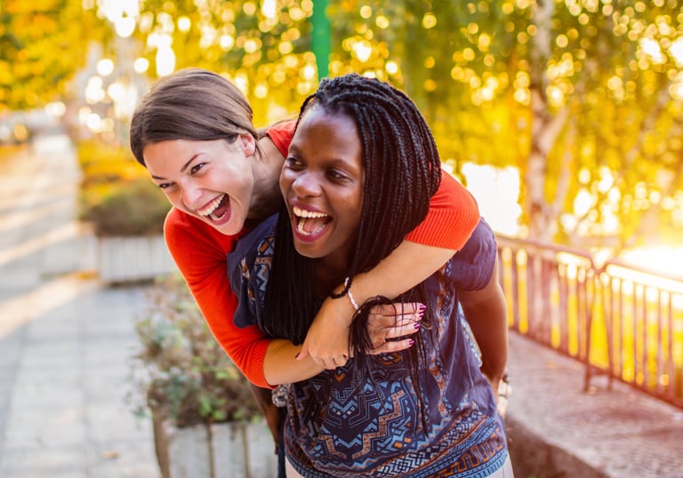 Two women laugh together