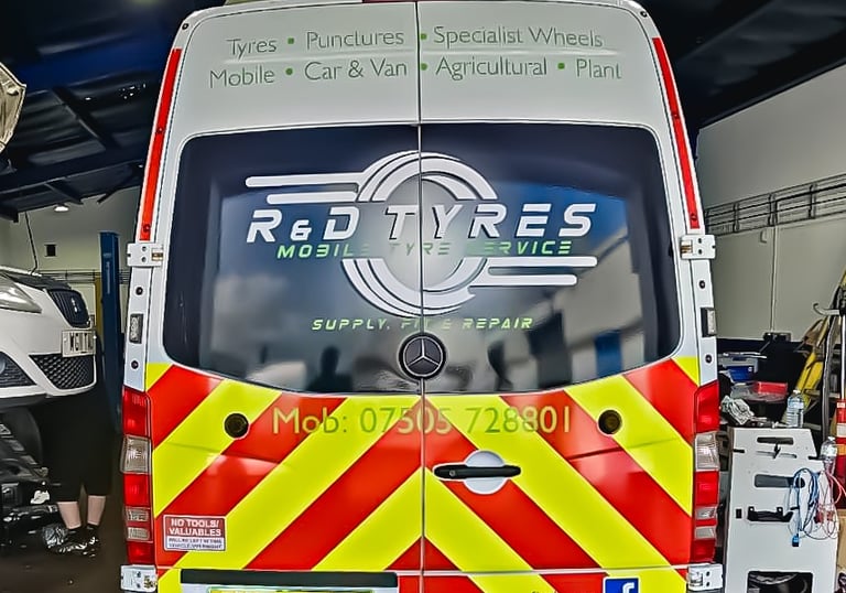 R&D Tyres mobile tyre service van inside a garage for puncture repair and wheel fitting.