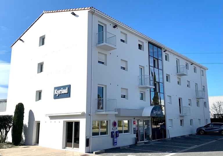 a building with a parking lot and a parking lot