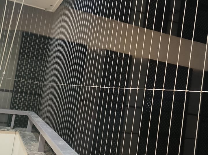 A sleek invisible grill installed on a window, offering security without blocking the view.