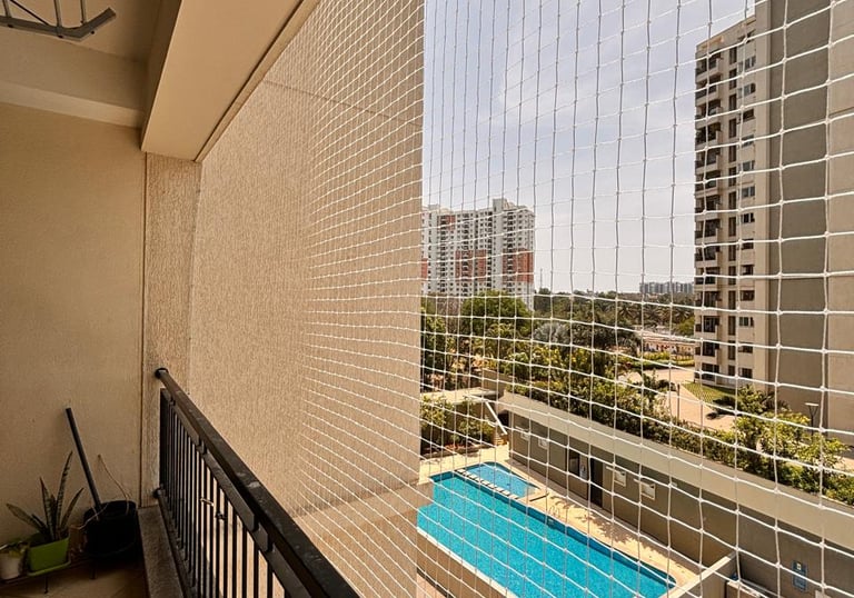 Close-up of a balcony safety net installed on a modern apartment building.