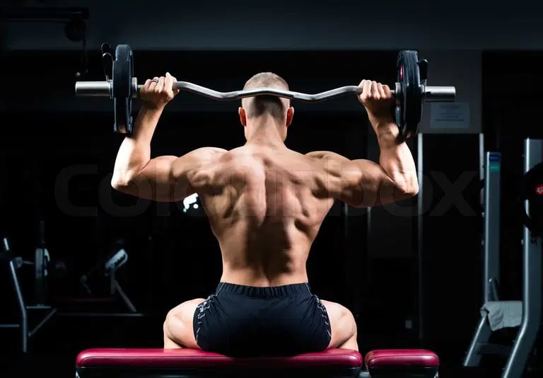 a man doing a back - up on a bench with a barbell
