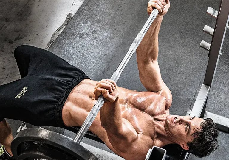 a man doing a barbell reverse grip bench press exercise on a bench