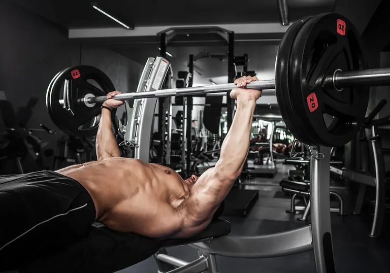 a man doing a barbell spoto press exercise on a bench