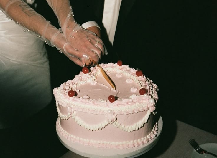 a bride and groom cutting their wedding cake