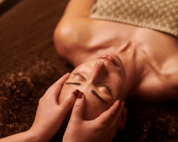 a man is getting a facial mask with a woman's face