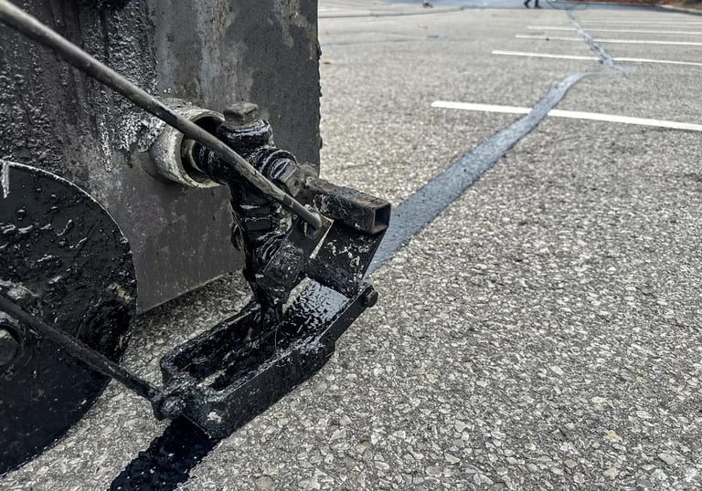 Professionally sealing parking lot cracks to avoid further damage and breakdown