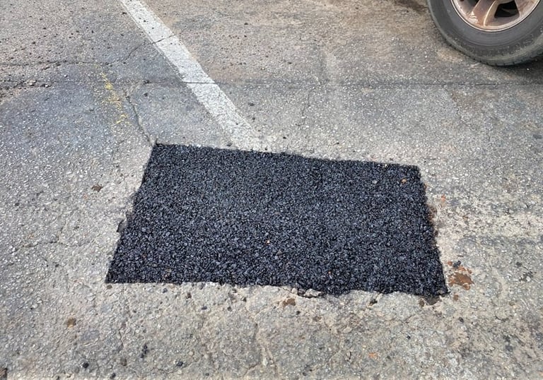 Patched parking lot pothole