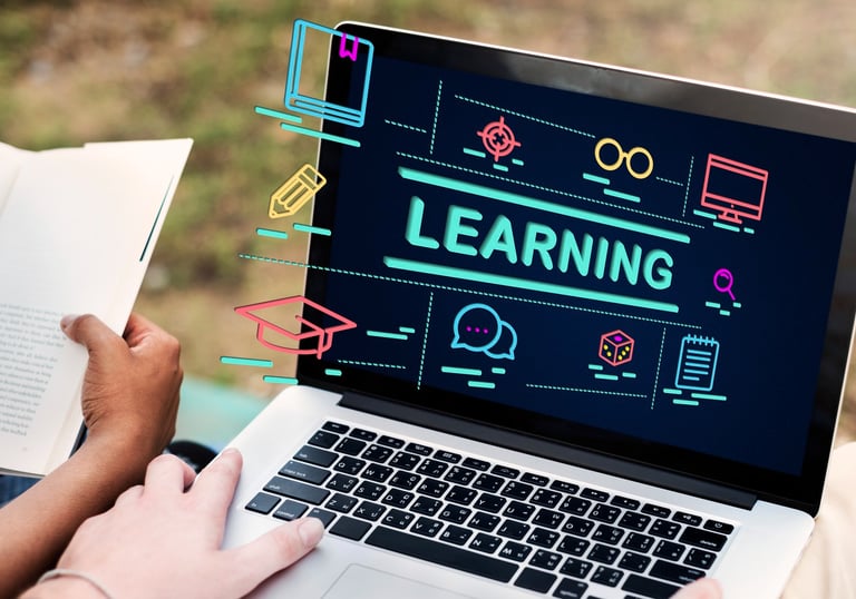 A laptop computer with the word "learning" rising off of the screen.