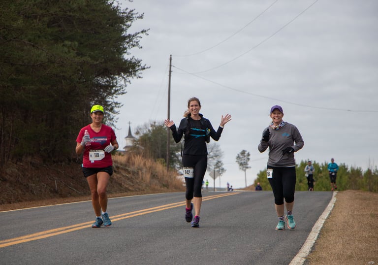 three runners on country road
