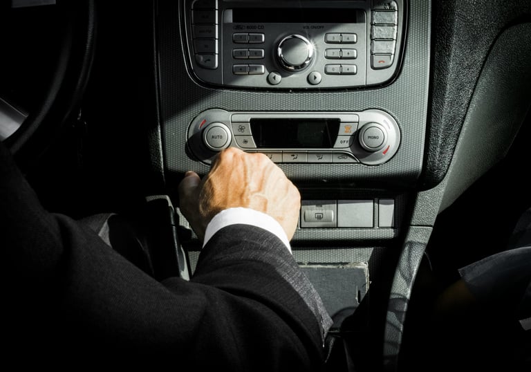 A driver is turning on a radio