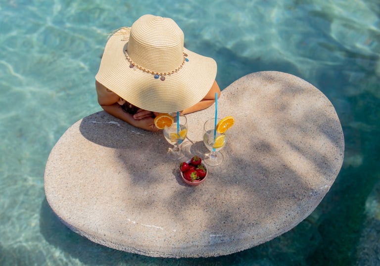 a woman in a straw hat sitting on a table