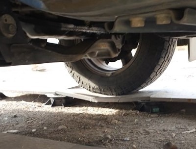 a car that is sitting on a broken tile that has been treated with SafePave