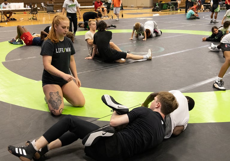 Wrestlers drilling with coach